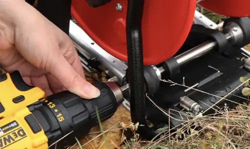 solinst power winder being used with standard drill to wind water level meter in the field